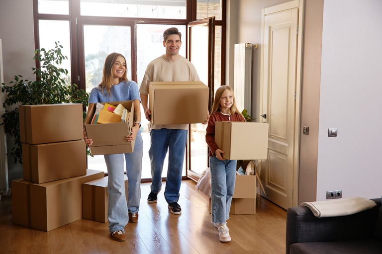 Happy family with boxes during moving day